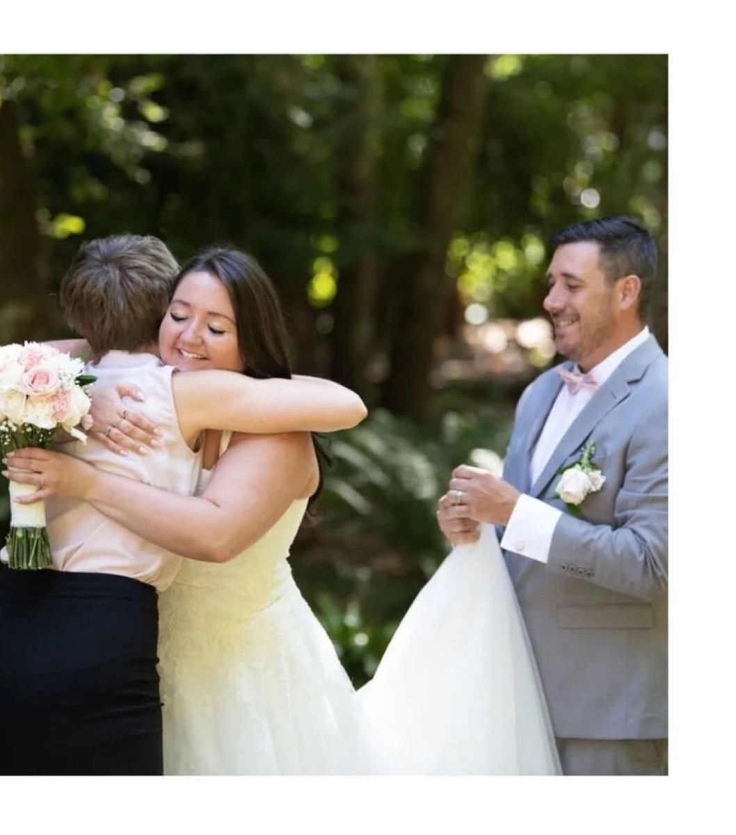 A bride embracing a guest at an intimate garden wedding ceremony