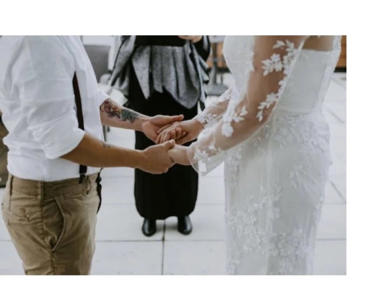 A couple holding hands during their handfasting ceremony